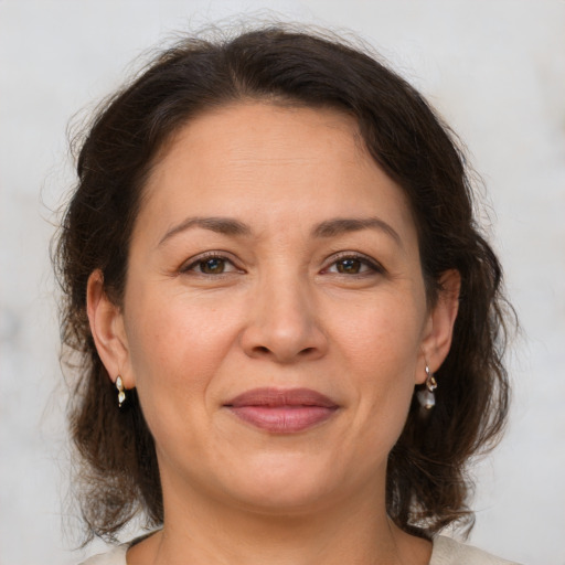 Joyful white adult female with medium  brown hair and brown eyes