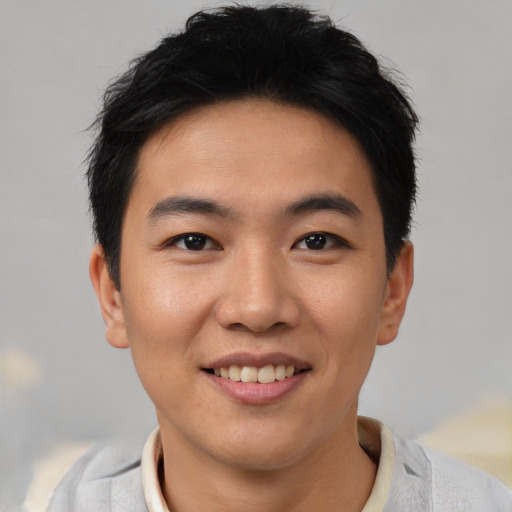 Joyful asian young-adult male with short  black hair and brown eyes