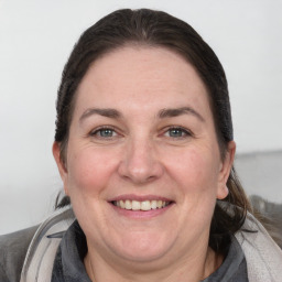 Joyful white adult female with medium  brown hair and grey eyes