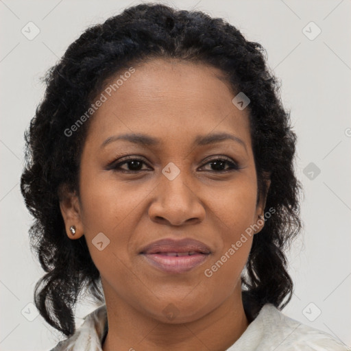 Joyful black adult female with medium  brown hair and brown eyes