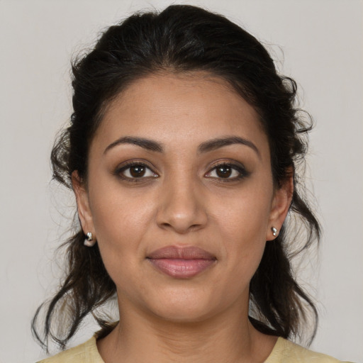 Joyful latino young-adult female with medium  brown hair and brown eyes