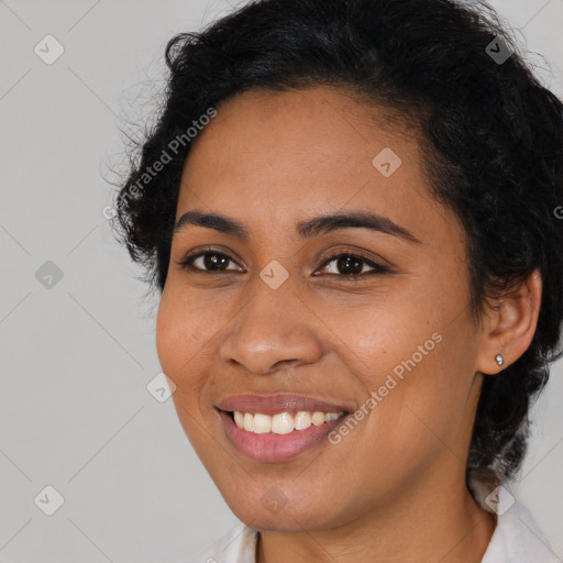 Joyful latino young-adult female with long  brown hair and brown eyes