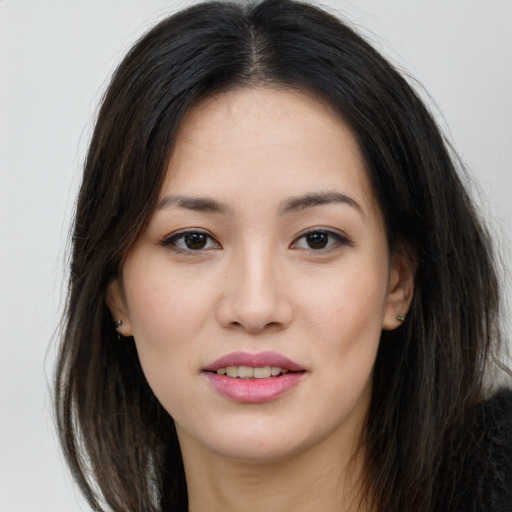 Joyful asian young-adult female with long  brown hair and brown eyes