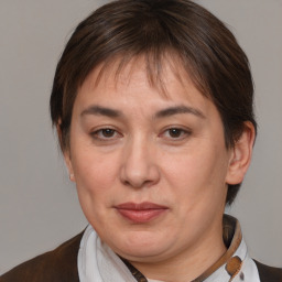 Joyful white adult female with medium  brown hair and brown eyes