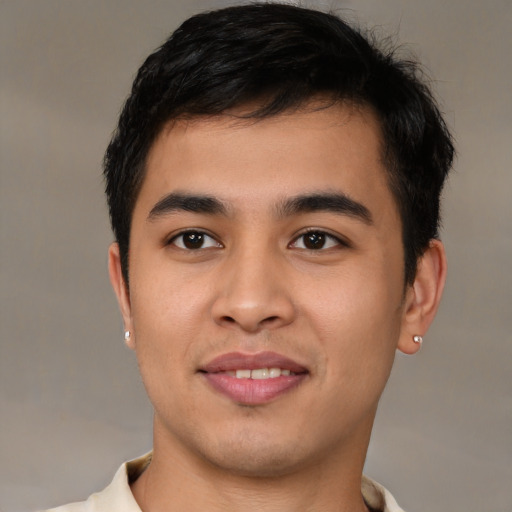 Joyful asian young-adult male with short  black hair and brown eyes