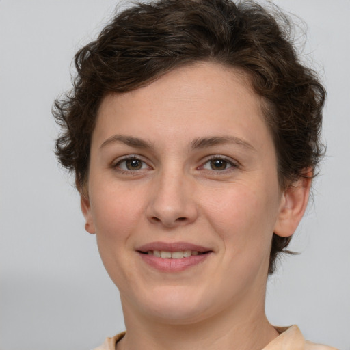 Joyful white young-adult female with medium  brown hair and green eyes