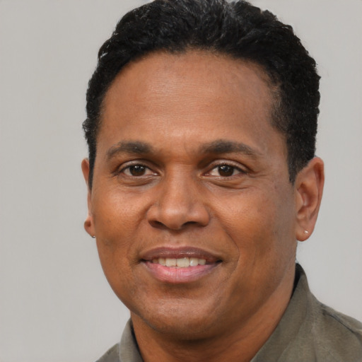 Joyful black adult male with short  brown hair and brown eyes