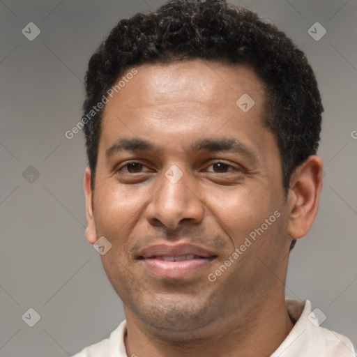 Joyful latino adult male with short  brown hair and brown eyes