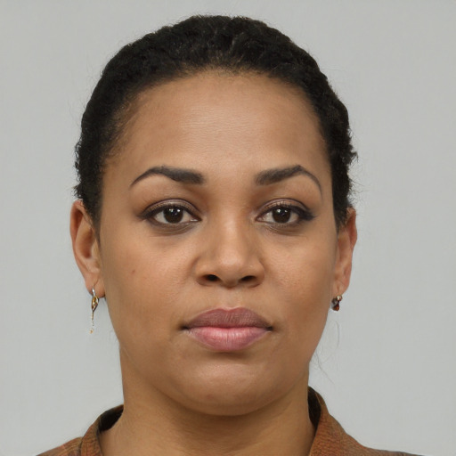 Joyful black young-adult female with short  black hair and brown eyes