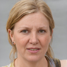 Joyful white adult female with medium  brown hair and blue eyes