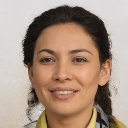 Joyful latino young-adult female with medium  brown hair and brown eyes