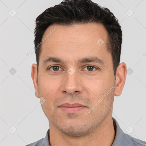 Joyful white adult male with short  black hair and brown eyes