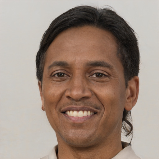 Joyful black adult male with short  brown hair and brown eyes