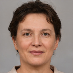 Joyful white adult female with short  brown hair and brown eyes