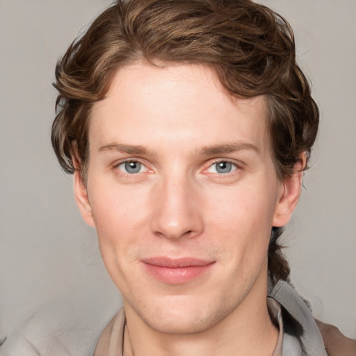 Joyful white young-adult male with medium  brown hair and blue eyes