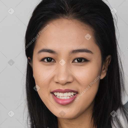 Joyful asian young-adult female with long  brown hair and brown eyes