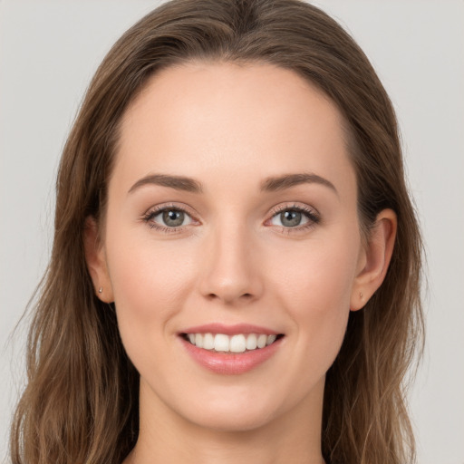 Joyful white young-adult female with long  brown hair and grey eyes