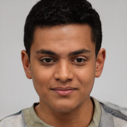 Joyful latino young-adult male with short  brown hair and brown eyes