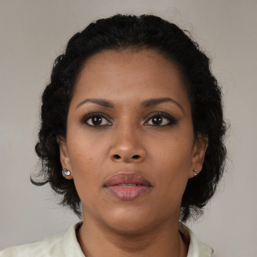 Neutral black young-adult female with medium  brown hair and brown eyes