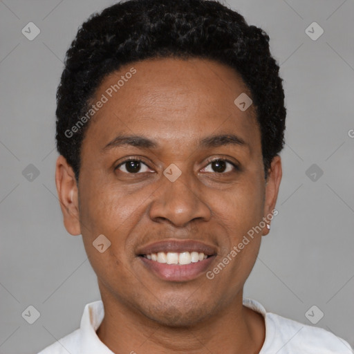 Joyful black adult male with short  black hair and brown eyes