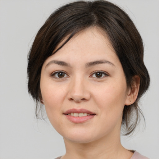 Joyful white young-adult female with medium  brown hair and brown eyes