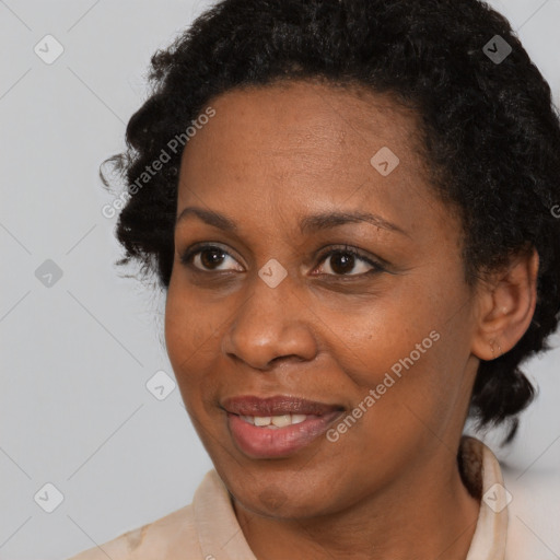 Joyful black adult female with medium  brown hair and brown eyes