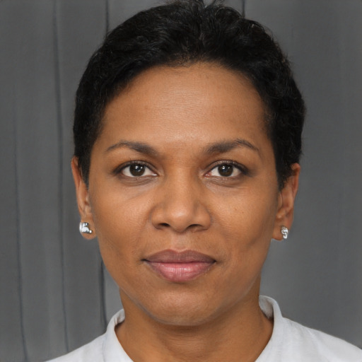 Joyful black adult female with short  black hair and brown eyes