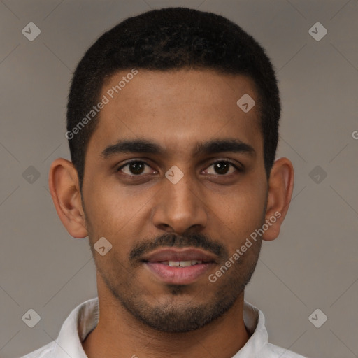 Joyful black young-adult male with short  brown hair and brown eyes