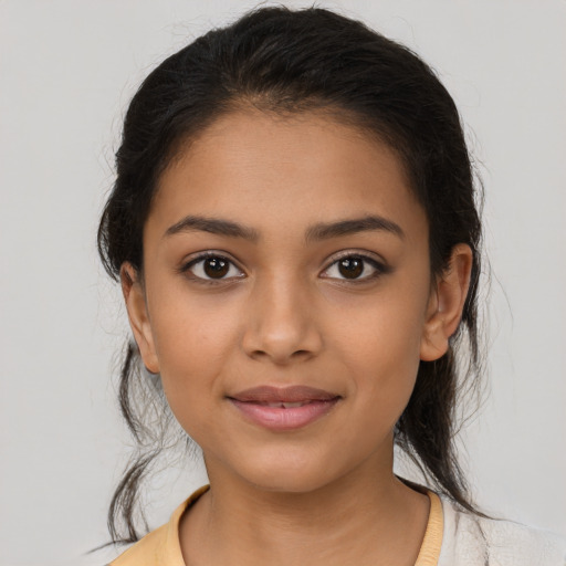 Joyful latino young-adult female with medium  brown hair and brown eyes