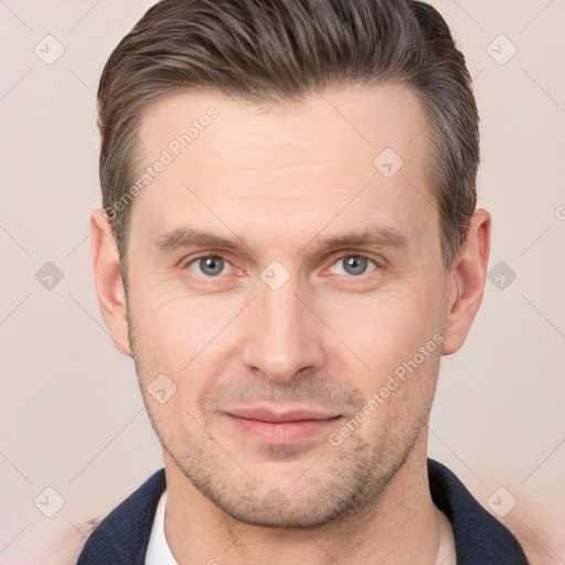 Joyful white adult male with short  brown hair and brown eyes