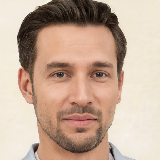 Joyful white young-adult male with short  brown hair and brown eyes