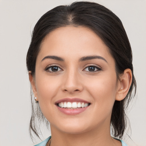 Joyful white young-adult female with medium  brown hair and brown eyes