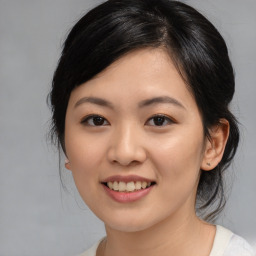 Joyful asian young-adult female with medium  black hair and brown eyes