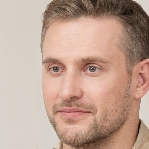 Joyful white adult male with short  brown hair and grey eyes