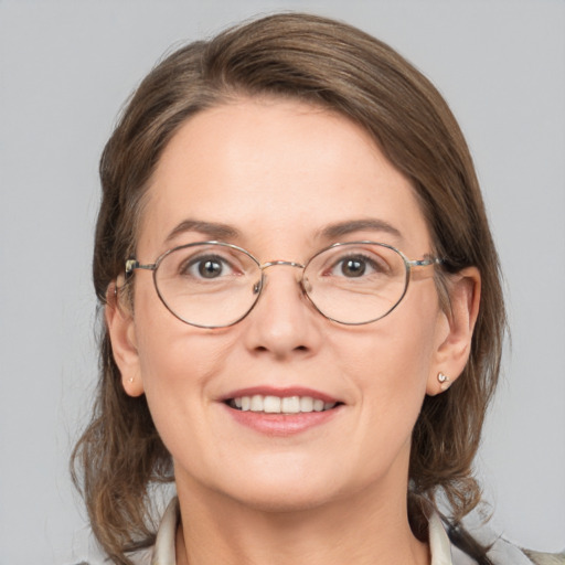 Joyful white adult female with medium  brown hair and grey eyes