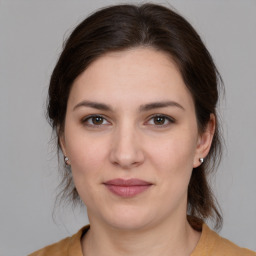 Joyful white young-adult female with medium  brown hair and brown eyes