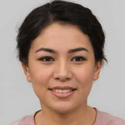 Joyful asian young-adult female with short  brown hair and brown eyes