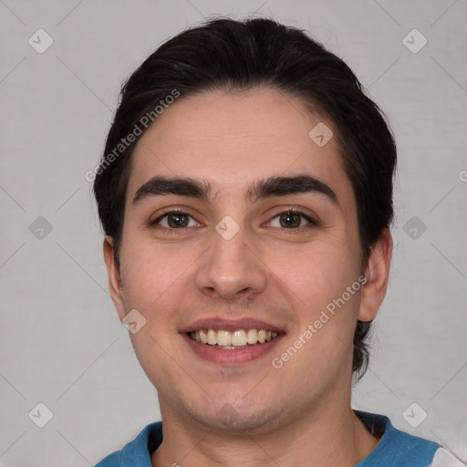 Joyful white young-adult male with short  brown hair and brown eyes