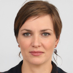 Joyful white young-adult female with medium  brown hair and grey eyes