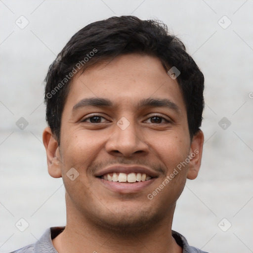 Joyful latino young-adult male with short  brown hair and brown eyes