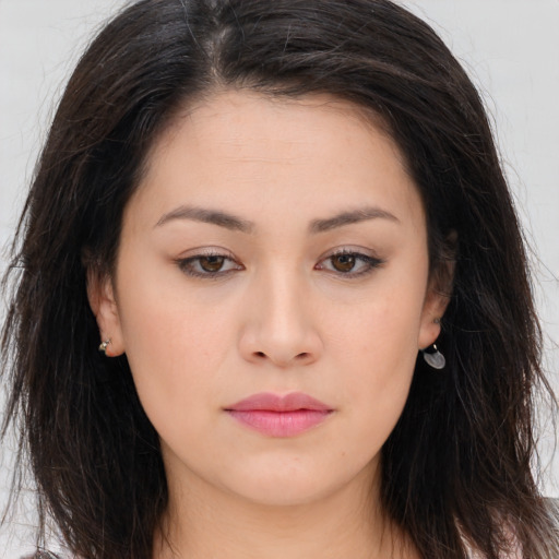 Joyful asian young-adult female with long  brown hair and brown eyes