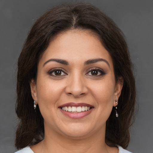 Joyful white young-adult female with medium  brown hair and brown eyes