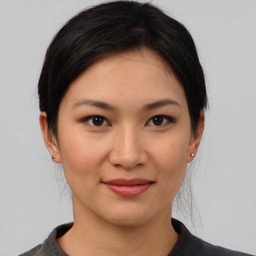 Joyful white young-adult female with medium  black hair and brown eyes