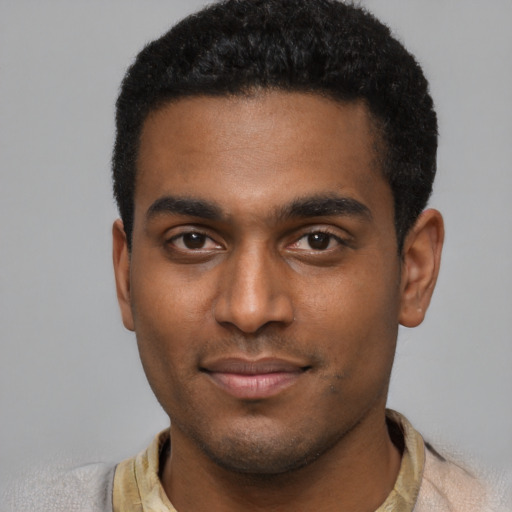 Joyful black young-adult male with short  black hair and brown eyes