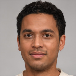 Joyful latino young-adult male with short  brown hair and brown eyes