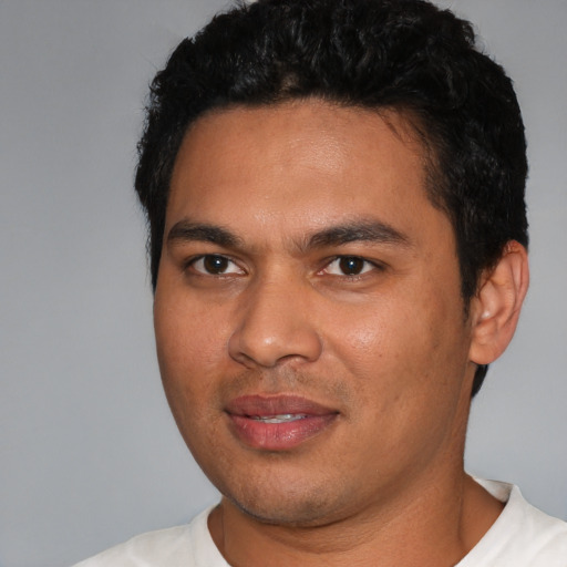 Joyful white young-adult male with short  black hair and brown eyes