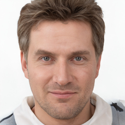 Joyful white adult male with short  brown hair and grey eyes