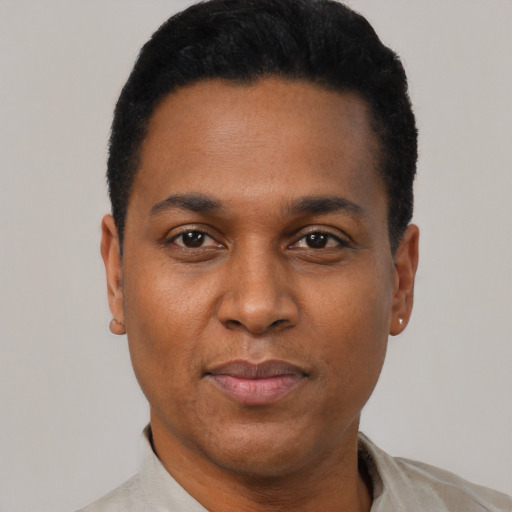 Joyful black young-adult male with short  black hair and brown eyes