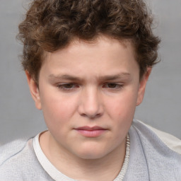 Joyful white child male with short  brown hair and brown eyes