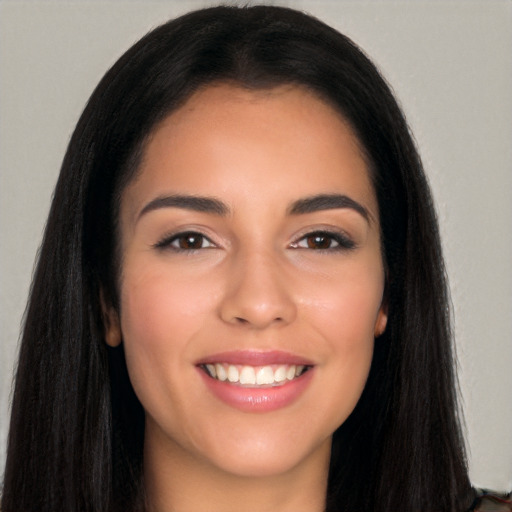 Joyful white young-adult female with long  black hair and brown eyes